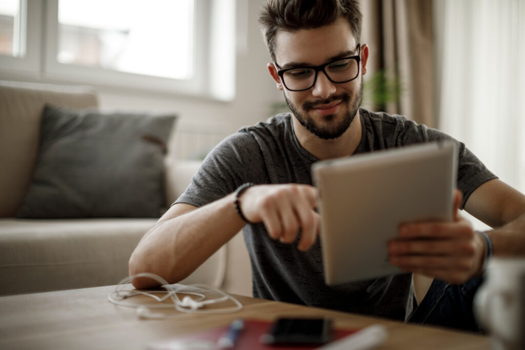 young man looking at a tablet device